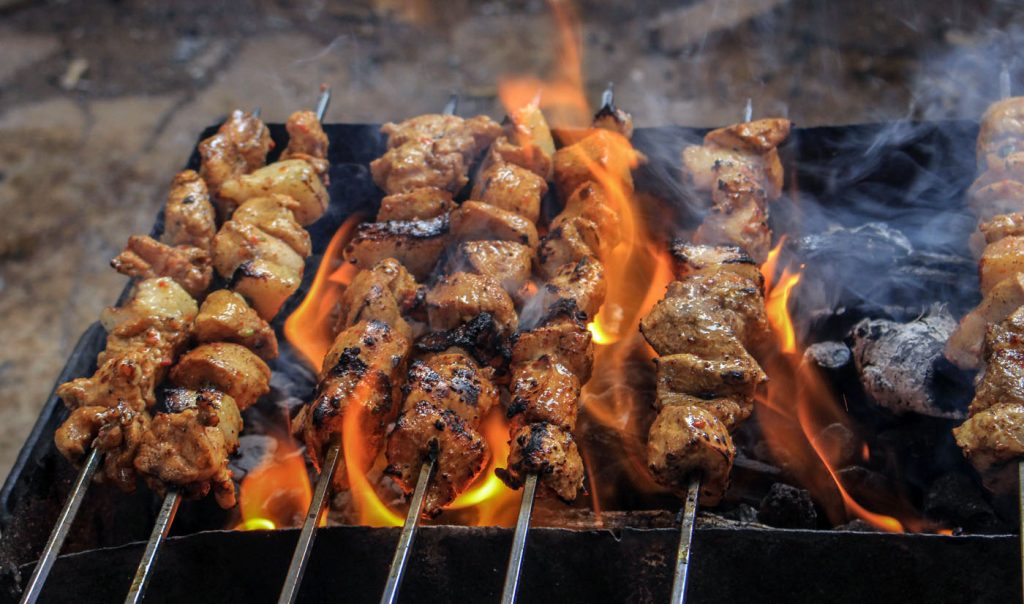 Grilled Meats on Skewers over campfire
