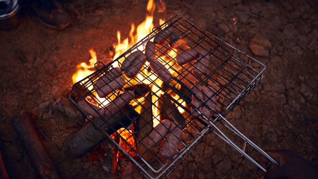 Sausages getting grilled on the Campfie