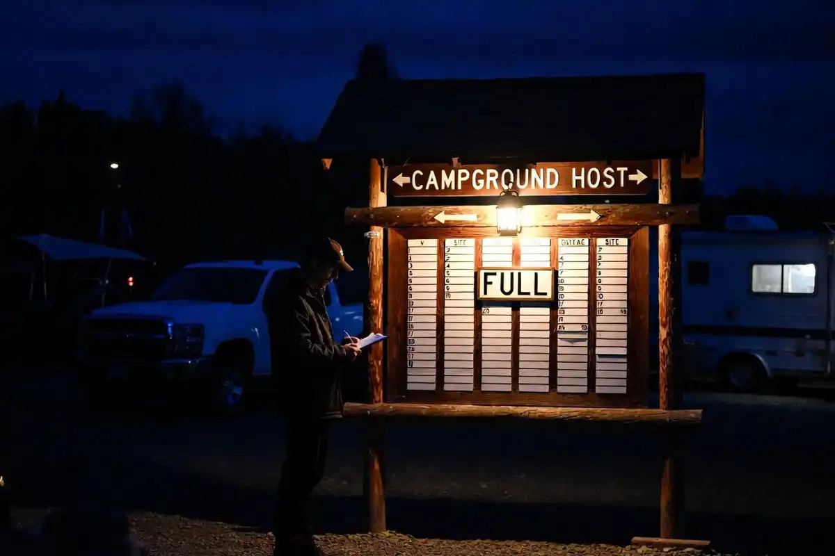 checking campground host board for available sites at night