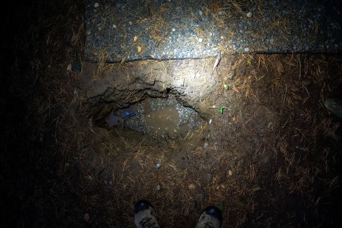 shallow runoff channel near tent pad after rain risk