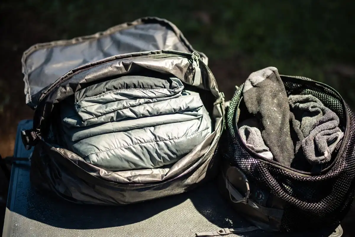 sleeping bag stored in a waterproof dry bag beside a separate wet bag