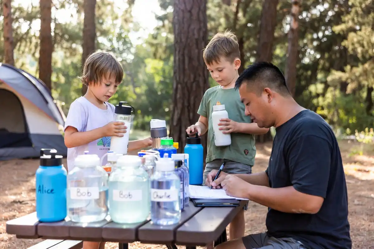 family organizing water supply at campsite