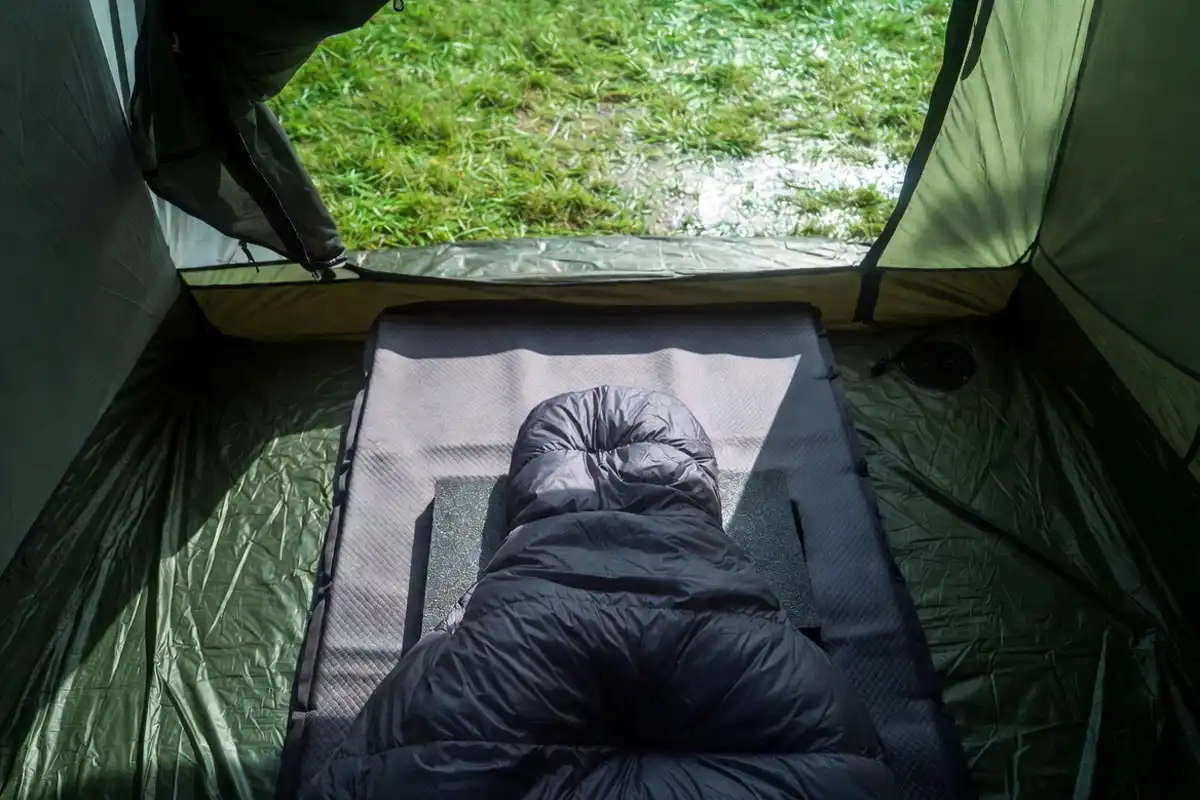 groundsheet and sleeping pad layered to keep bedding off wet ground