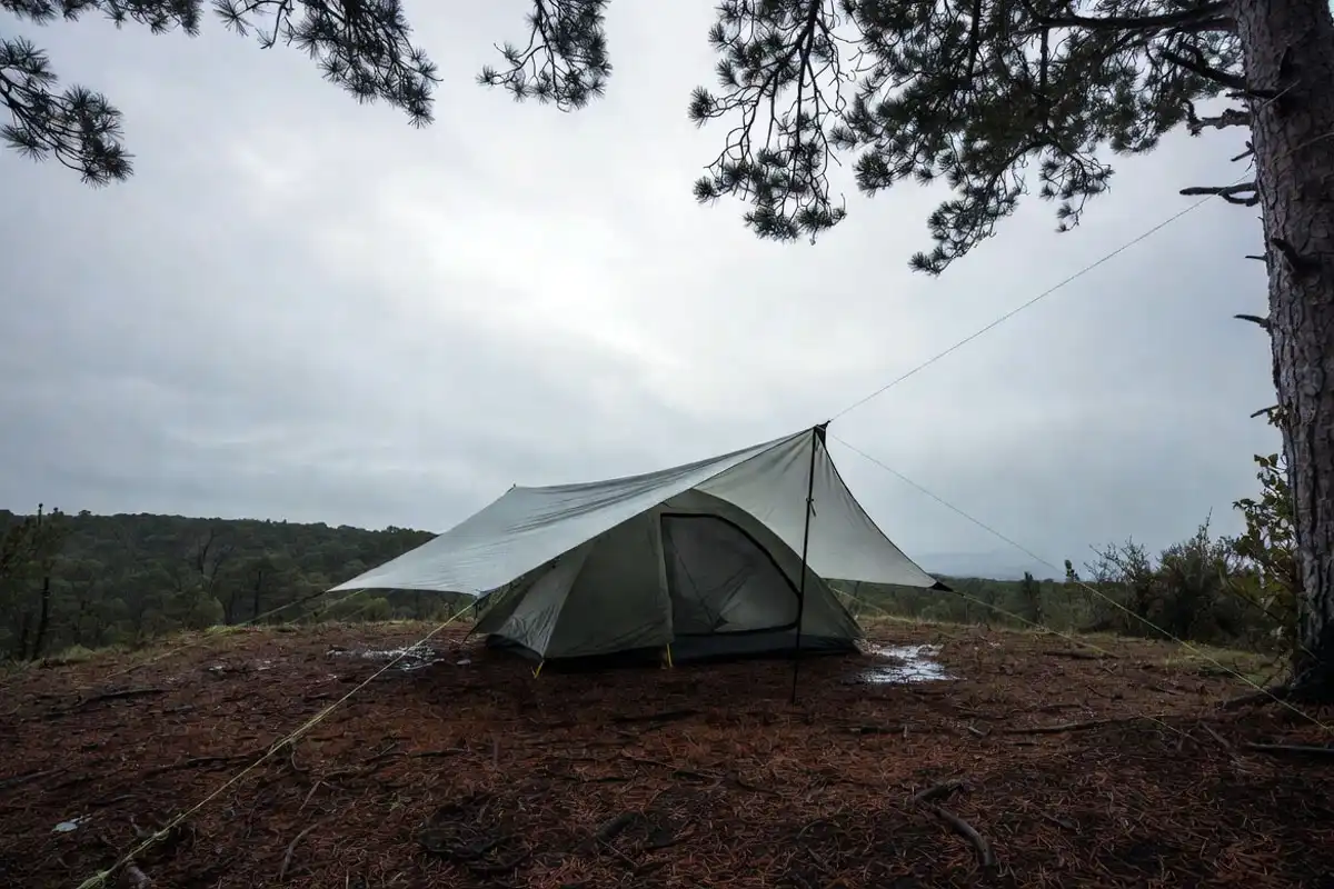 low A frame tarp pitched over tent for storm rain