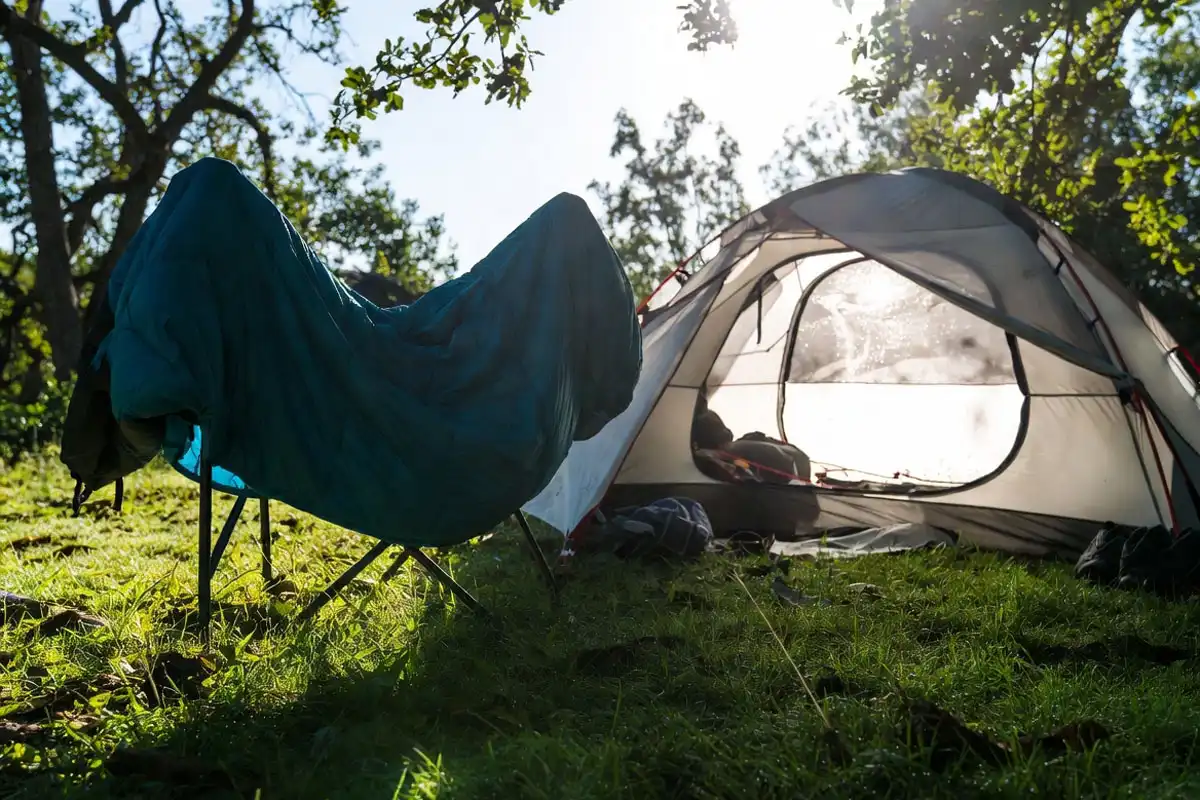 sleeping bag draped over a line to air out in humid morning