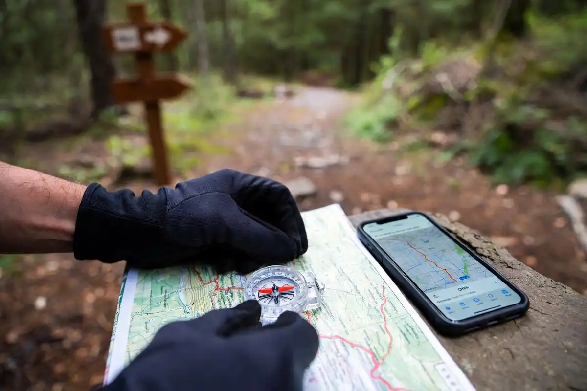 compass and paper map with offline map on phone