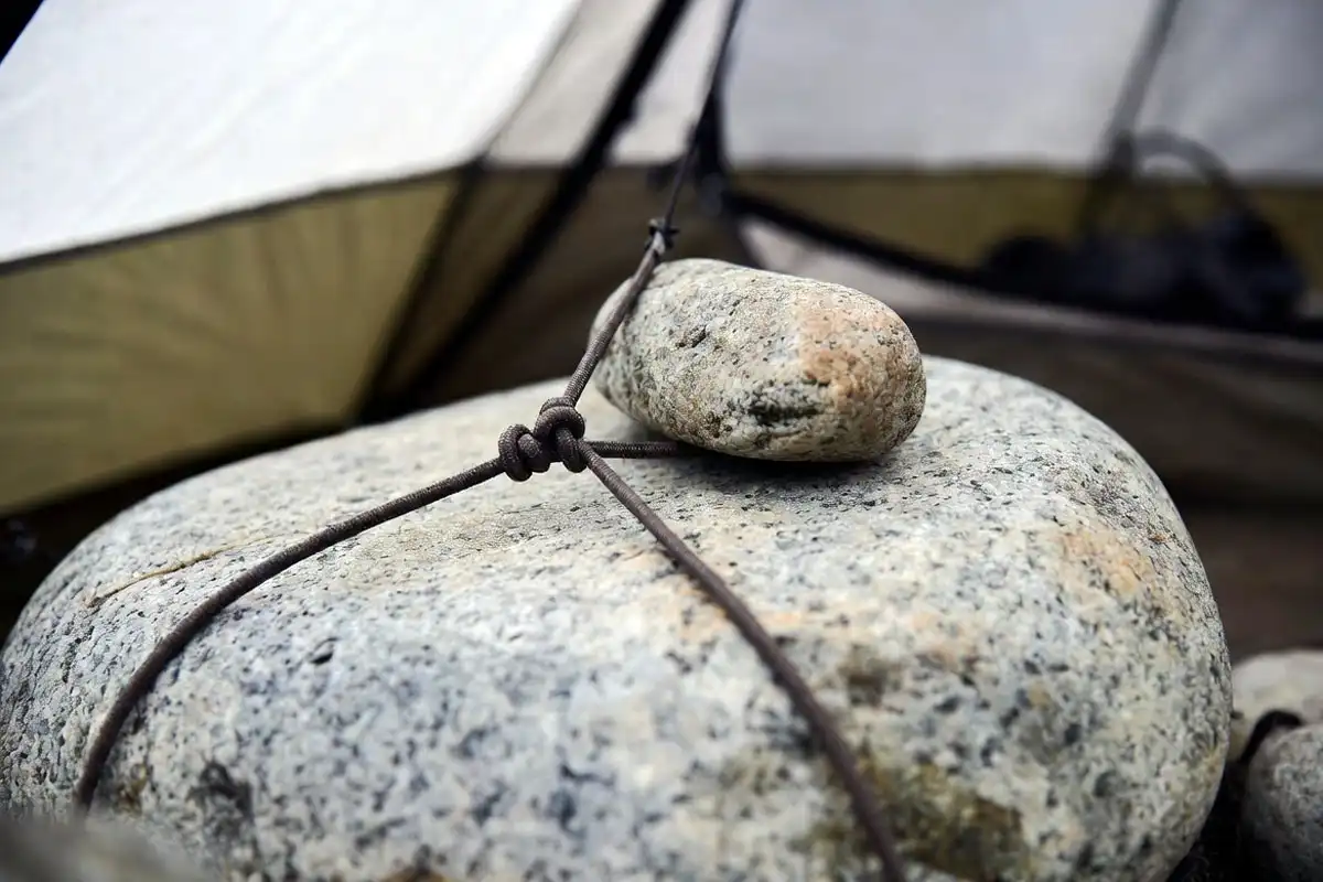 guyline trapped under small rock on slab