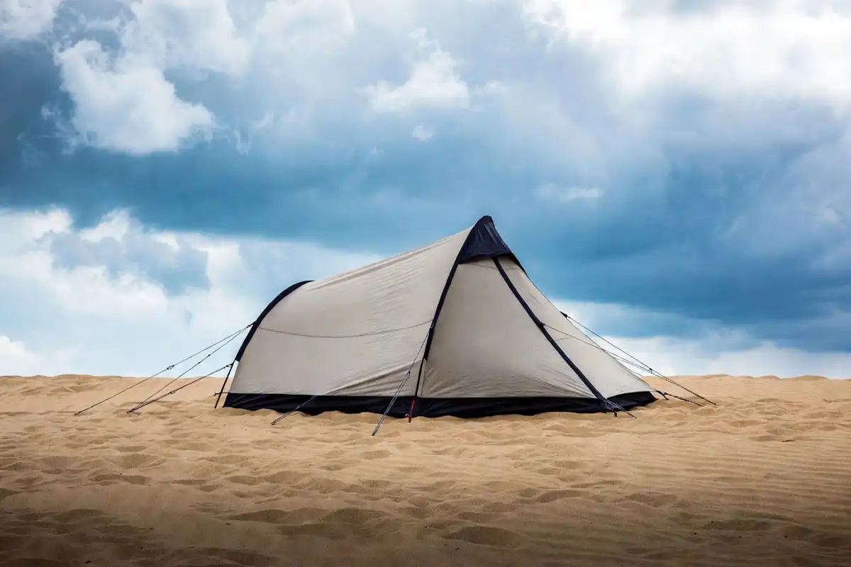 low profile tent pitched into wind with guylines