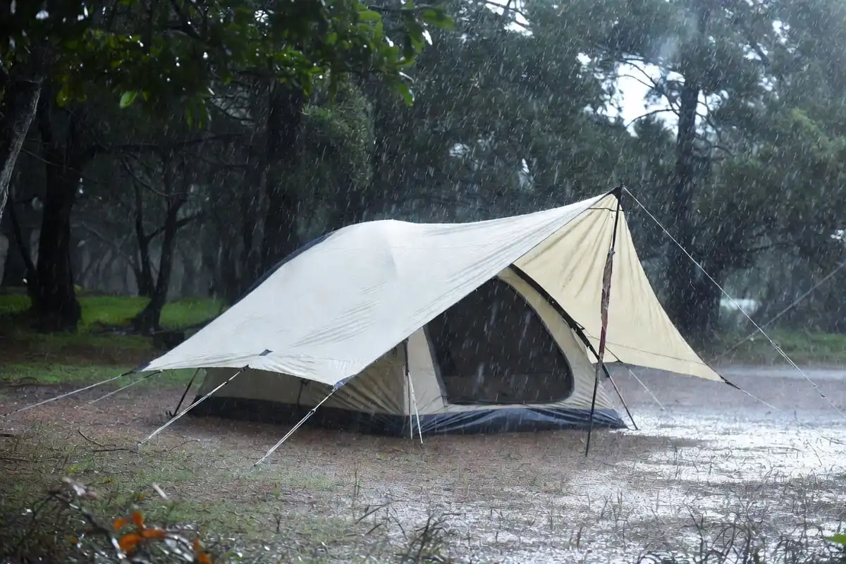 windward tarp edge extended to block wind driven rain