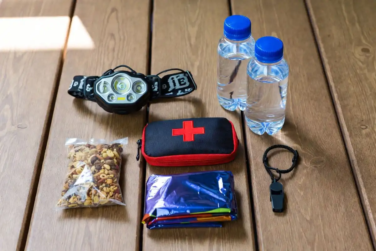 day hike safety essentials including headlamp water whistle and first aid kit