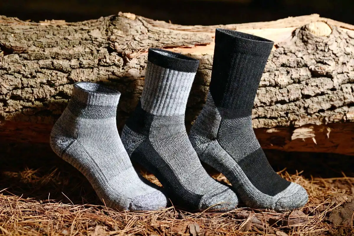 three hiking socks showing different cushion thickness levels