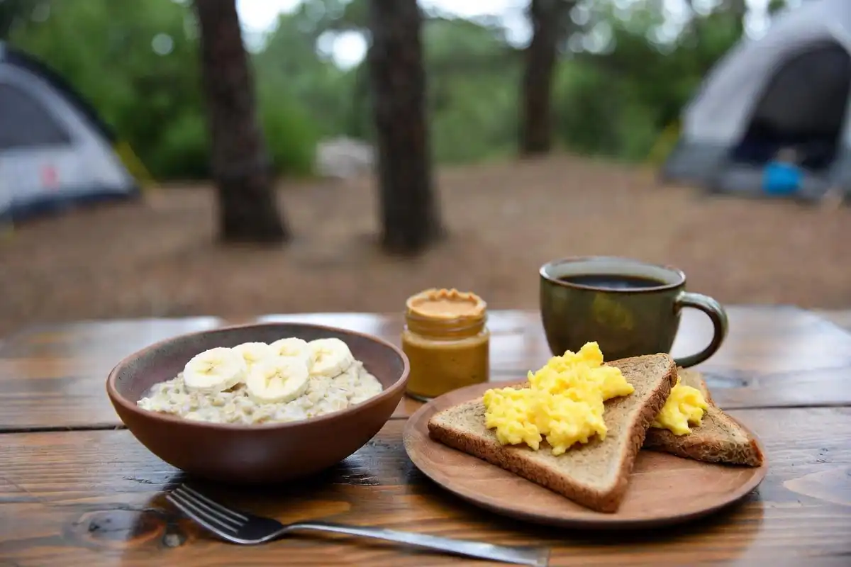 oatmeal eggs and toast on a camping table as a pre hike breakfast