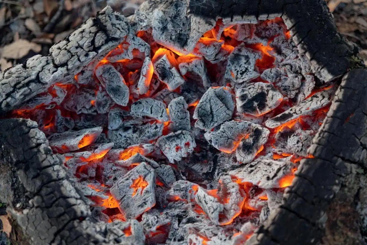 glowing orange embers with white ash crust ready for direct heat cooking