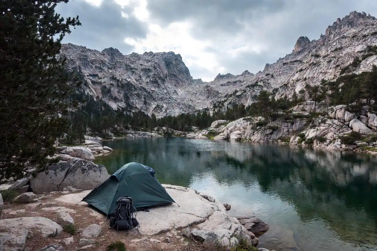 ultralight backpacking tent pitched near a mountain lake in a remote wilderness area
