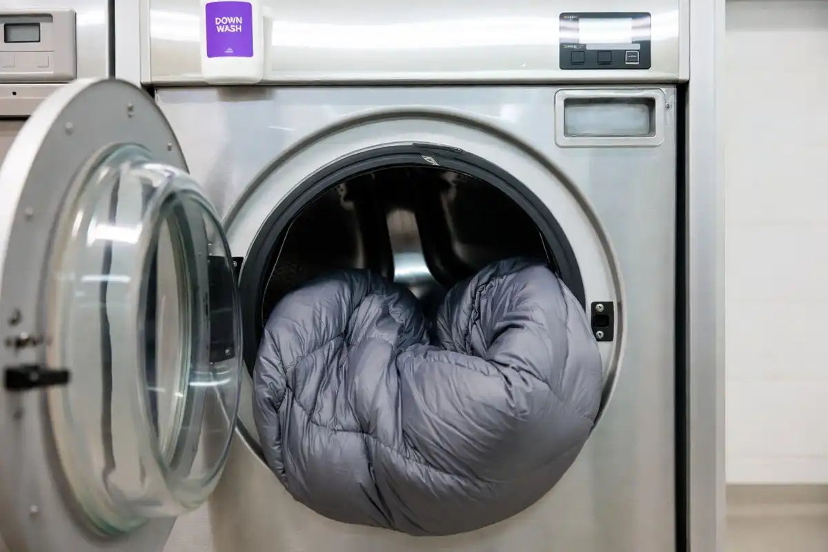 Down sleeping bag loaded inside a front loading washing machine