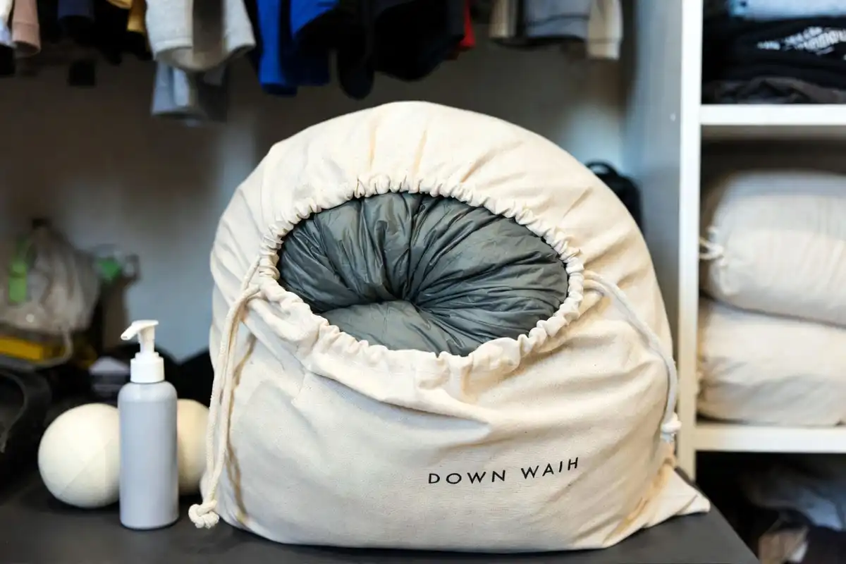 Down sleeping bag stored loosely in a large cotton storage sack