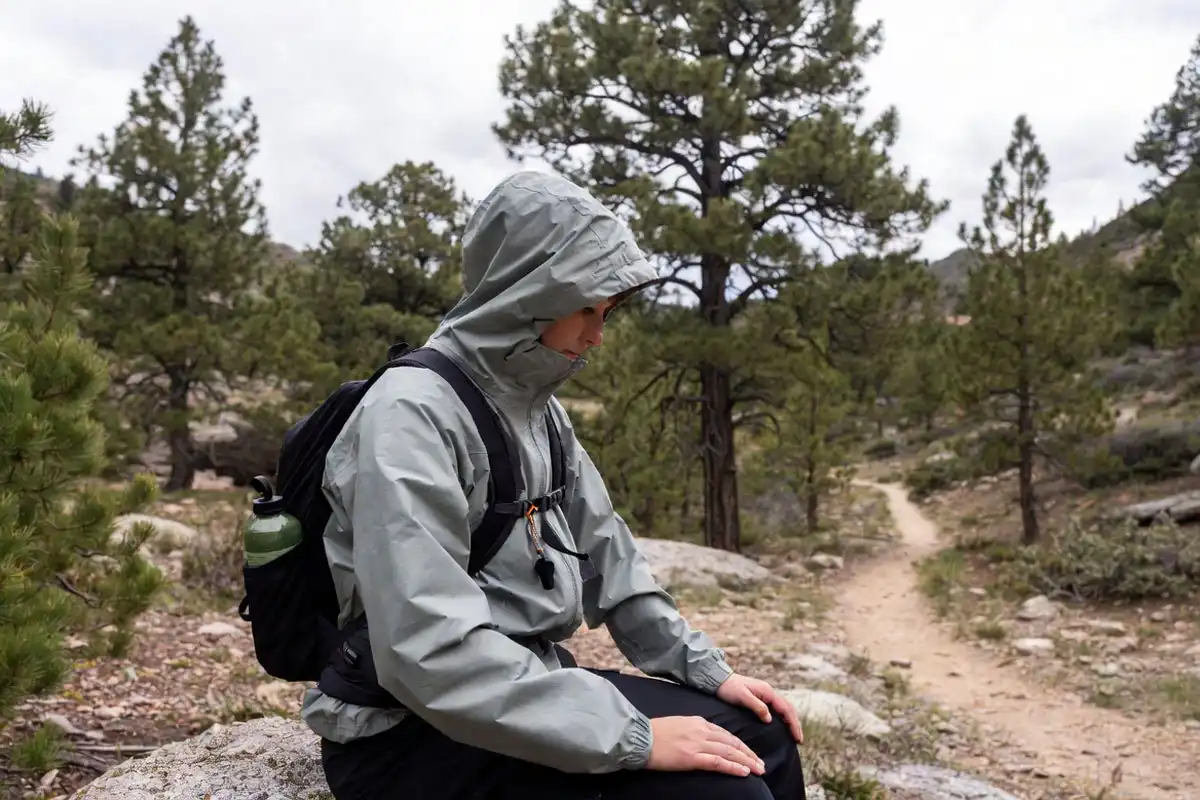 hiker stopping to regroup on a wooded trail