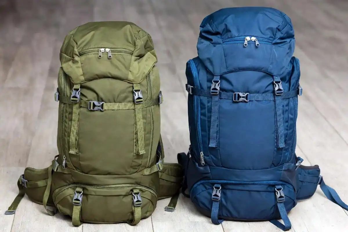 40L and 50L hiking backpacks placed side by side on wooden floor