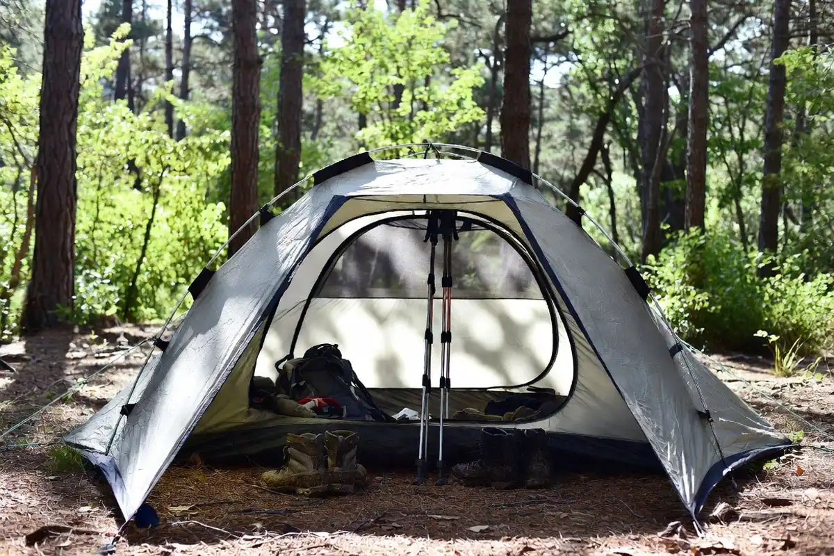 freestanding dome tent with both doors open and gear stored in vestibules