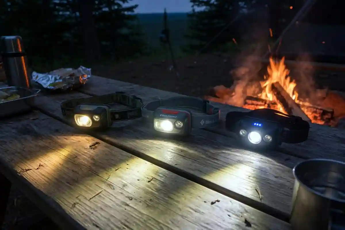 Three headlamps at different brightness levels at a campsite