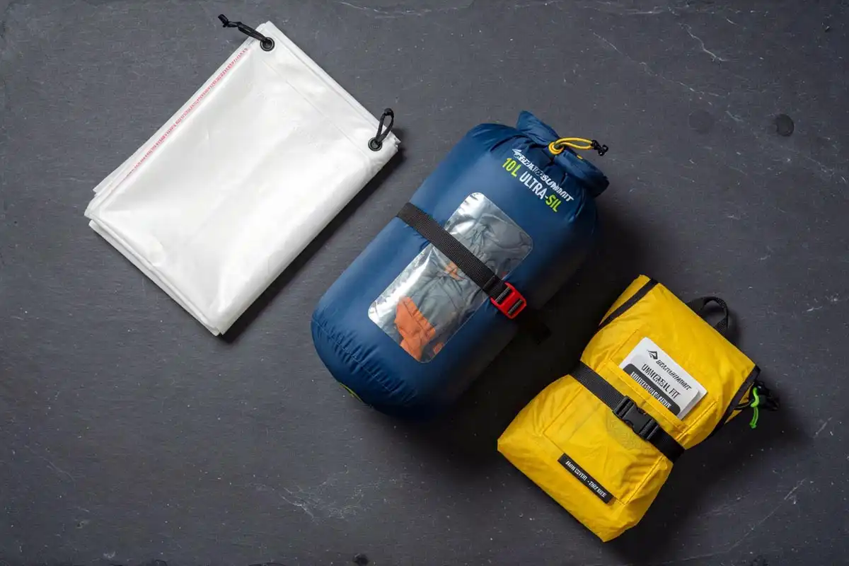 Trash compactor bag liner, compression sack, and backpack rain cover arranged for packing