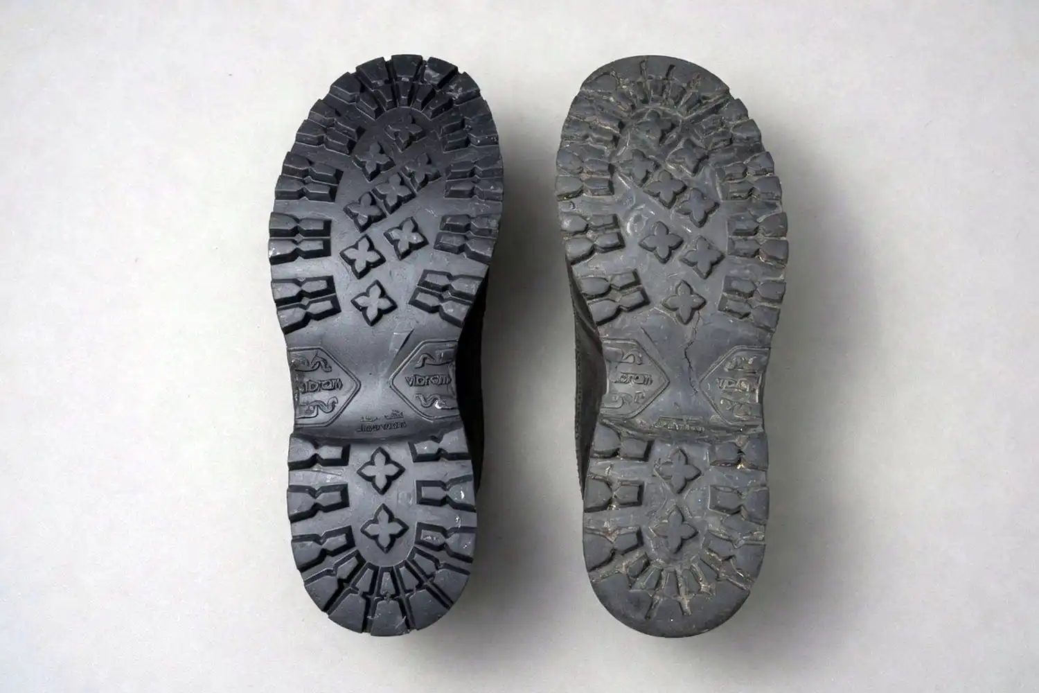 Side by side comparison of a new hiking boot outsole with deep lugs and a worn outsole with flattened tread