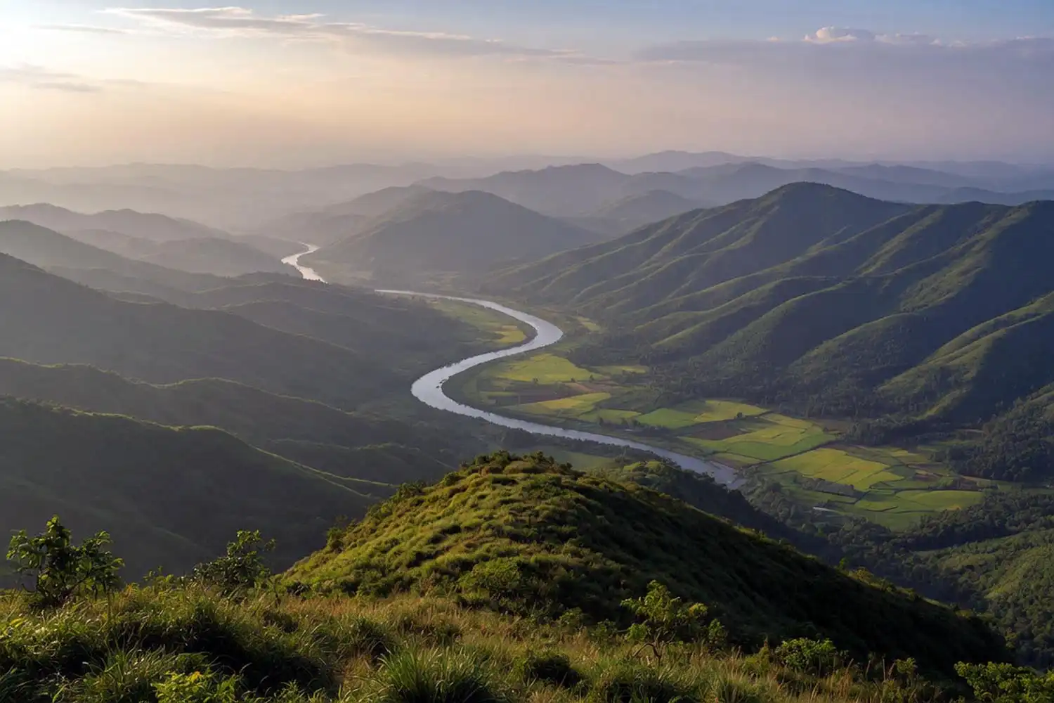 Panoramic view from the top of Marayon Thong with the Matamuhuri river winding through the valley and rows of hills to the horizon